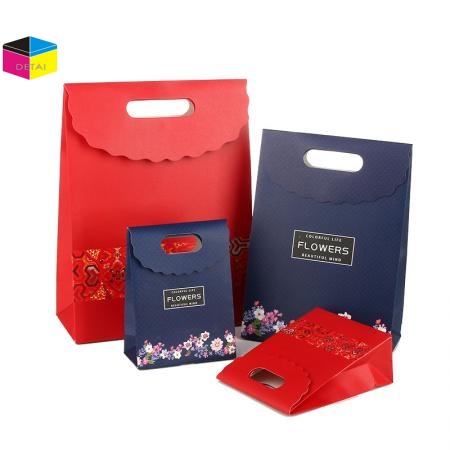 Paper shopping bags with die cut handle 